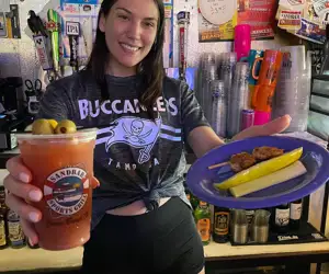 Sandbar Bartender with grilled shrimp for a Bloody Mary