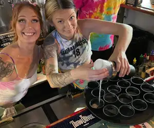 Bartenders pouring shots